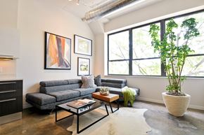 Chicago apartment for rent - a living room with a couch and a coffee table and a large window