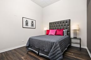 Chicago apartment for rent - a bedroom with a bed with red pillows