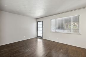 Dallas apartment for rent - an empty living room with wood floors and a large window