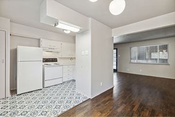 Dallas apartment for rent - A kitchen with white appliances and a blue and white tiled floor.