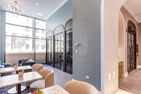 Chicago apartment for rent - a dining area with tables and chairs and a lobby with glass doors