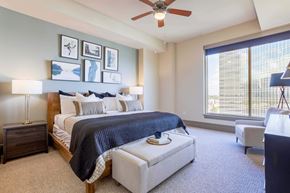 Houston apartment for rent - A bedroom with a large bed and a ceiling fan.