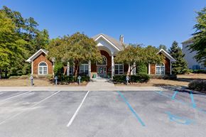 Columbia apartment for rent - the front of a house with a parking lot and trees