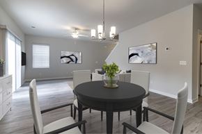 Guyton apartment for rent - a dining room with white chairs and a black table
