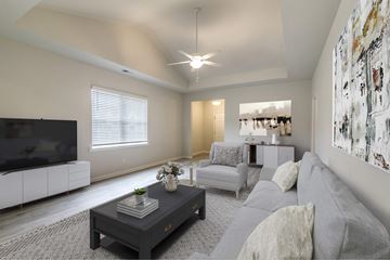 Guyton apartment for rent - A living room with a grey couch and a black coffee table.