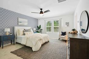 Bluffton apartment for rent - a bedroom with a bed and a ceiling fan