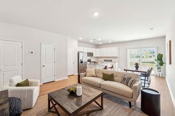 Pooler apartment for rent - A living room with a white couch and a coffee table.