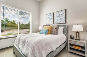 Pensacola apartment for rent - a bedroom with a bed and two windows