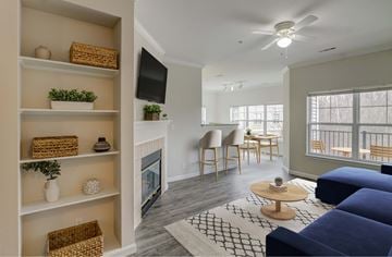 Haverhill apartment for rent - a living room with a blue couch and a fireplace