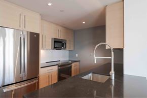 Charlestown apartment for rent - a kitchen with black counter tops and stainless steel appliances
