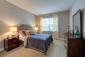 Salem apartment for rent - a bedroom with a bed and a dresser and a window