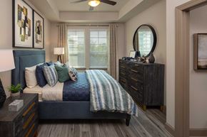 Atlanta apartment for rent - Bedroom with queen sized bed, dresser and nightstand, wood like floor, ceiling fan and large windows