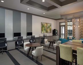 Atlanta apartment for rent - lounge area with imac computers, coffee machine, and various tables and seating areas.