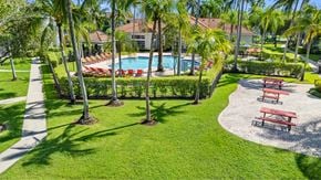 Tamarac apartment for rent - Outdoor view of large resort-style swimming pool with lounge chairs along deck. Covered poolside lounge area near pool. Direct access to clubhouse, which faces pool