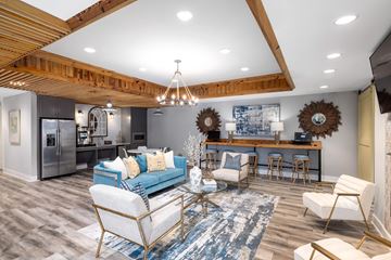 Myrtle Beach apartment for rent - A modern living room with a blue sofa and a wooden ceiling.