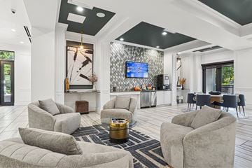 Dallas apartment for rent - A living room with grey couches and a television.