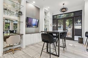 Dallas apartment for rent - A modern kitchen with a dining table and chairs.