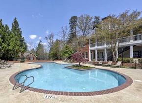 Gainesville apartment for rent - a large swimming pool in front of a house