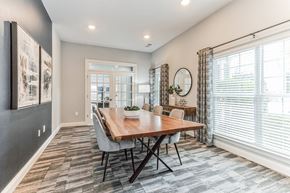 Gainsville apartment for rent - A dining room with a wooden table and chairs.