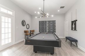 Gainesville apartment for rent - a game room with a pool table and a chandelier