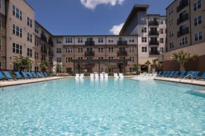 Plano apartment for rent - A large swimming pool in front of apartment buildings.