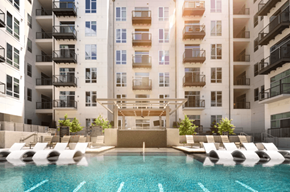 Plano apartment for rent - A large pool in front of a multi-story apartment building.