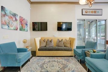 Mansfield apartment for rent - A living room with a blue couch and a rug.