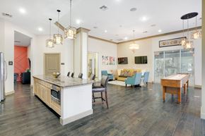Mansfield apartment for rent - A kitchen with a white island and a dining table with chairs.