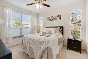 Mansfield apartment for rent - A bedroom with a bed, nightstand, and a ceiling fan.