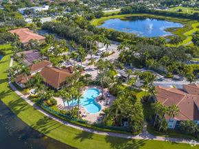 Delray Beach apartment for rent - A beautiful aerial view of a resort with a swimming pool and palm trees.