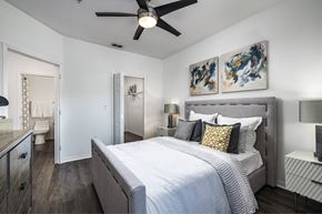 Orlando apartment for rent - A bedroom with a large bed and a ceiling fan.