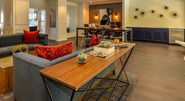 Atlanta apartment for rent - A modern living room with a grey couch and a wooden coffee table.