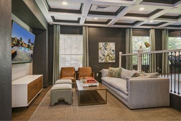 Orlando apartment for rent - A living room with a grey couch, a coffee table, and a painting on the wall.