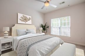 Wilmington apartment for rent - A bedroom with a bed, nightstands, and a ceiling fan.