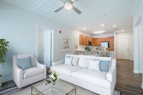 Wilmington apartment for rent - A living room with a white couch, two chairs, and a coffee table.