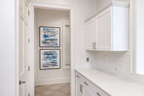 Orlando apartment for rent - A white kitchen with a white counter top and white cabinets.