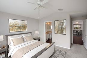 Orlando apartment for rent - A bedroom with a large bed and a ceiling fan.