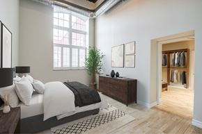 Menands apartment for rent - A bedroom with a large bed and a wooden dresser.