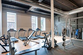 Cohoes apartment for rent - A gym with treadmills, weights, and a bench.