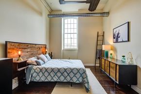 Cohoes apartment for rent - A bedroom with a bed, nightstand, and a window.