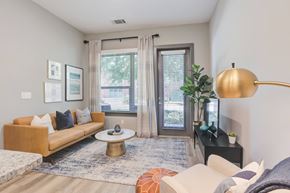 Columbia apartment for rent - A living room with a sofa, a coffee table, a lamp, and a plant.