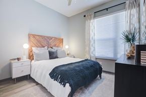 Columbia apartment for rent - A bedroom with a bed, nightstand, and window.