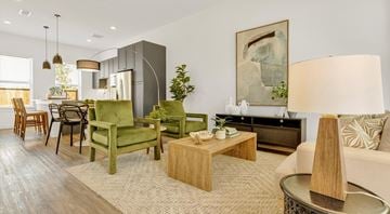 Denton apartment for rent - A living room with a green chair and a wooden coffee table.