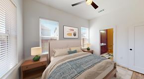 Denton apartment for rent - a bedroom with a bed and a ceiling fan