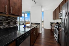Chicago apartment for rent - A modern kitchen with dark wood cabinets and stainless steel appliances.