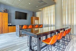 Chicago apartment for rent - A conference room with a long table and orange chairs.