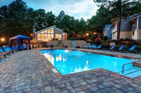 Birmingham apartment for rent - A swimming pool surrounded by a brick patio and lounge chairs.