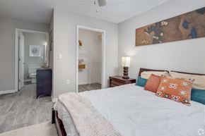 Columbia apartment for rent - A bedroom with a bed, a nightstand, and a painting on the wall.