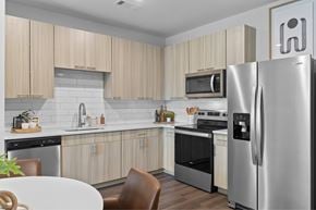 Greenville apartment for rent - A modern kitchen with a refrigerator on the right side.