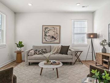 Madison apartment for rent - A living room with a grey couch, a coffee table, and a painting on the wall.